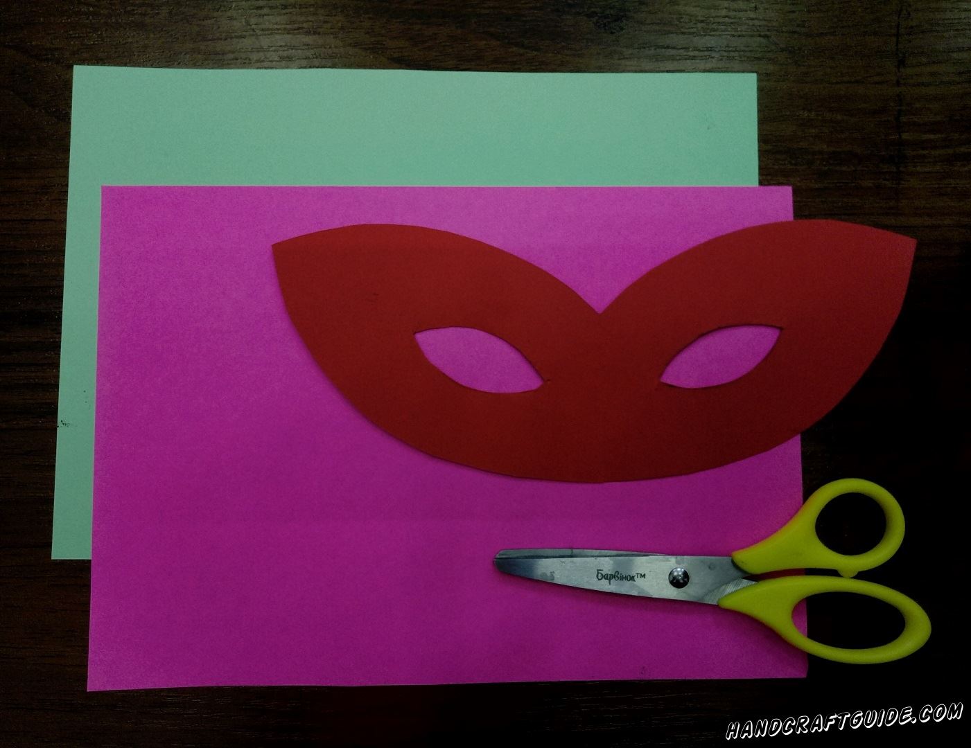 First, take red paper and cut out the basis of the mask, do not forget to cut holes for the eyes, so you can see when you wear it.